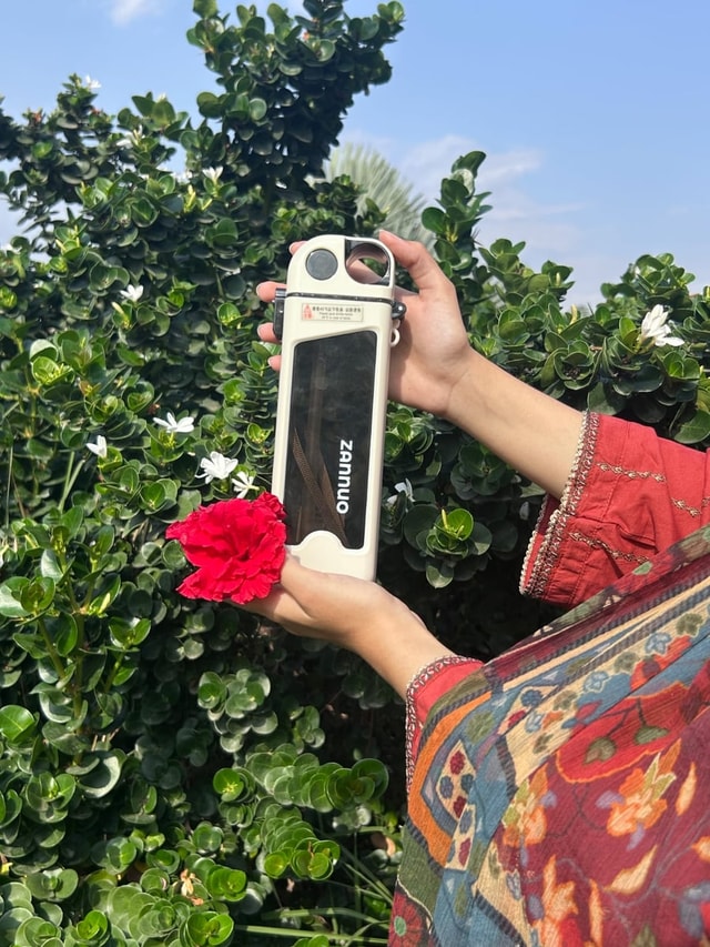 Customer holding Zanuo bottle with flower, portrait 8